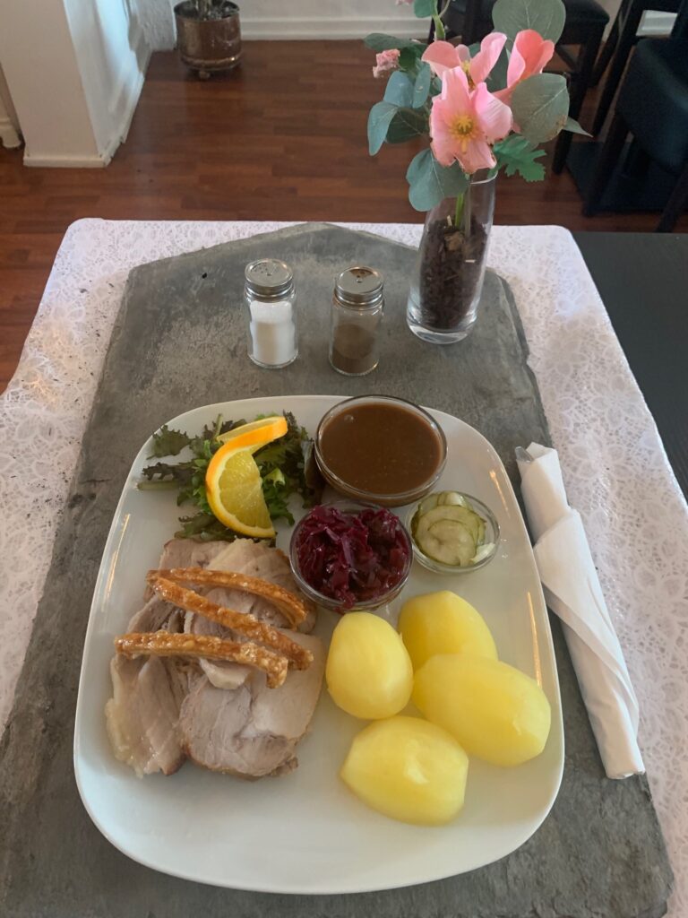 flaeskesteg-med-sproede-svaer-kartofler-roedkaal-og-sauce